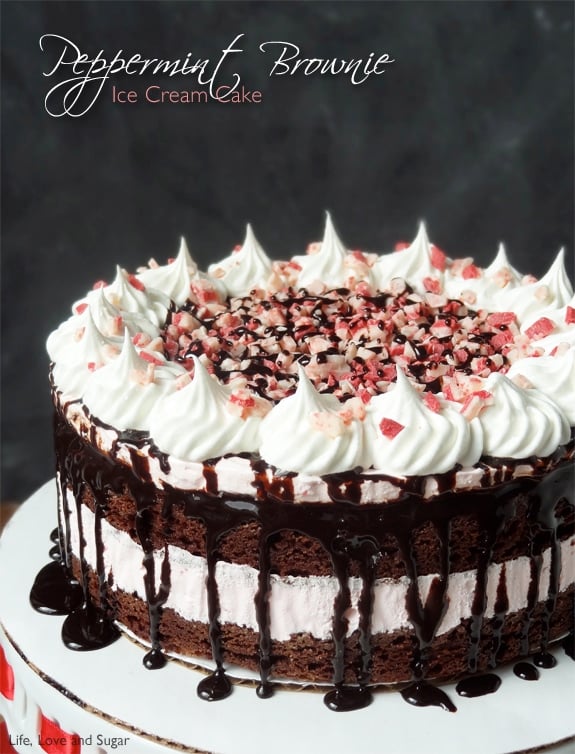 Peppermint Brownie Ice Cream Cake with fudge dripping down on a white platter