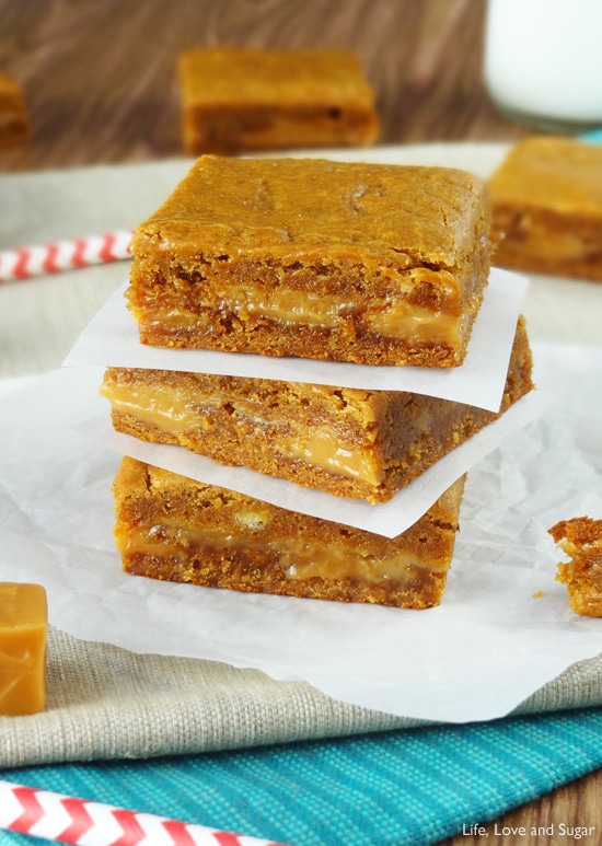 Three Gooey Bars stacked with wax paper