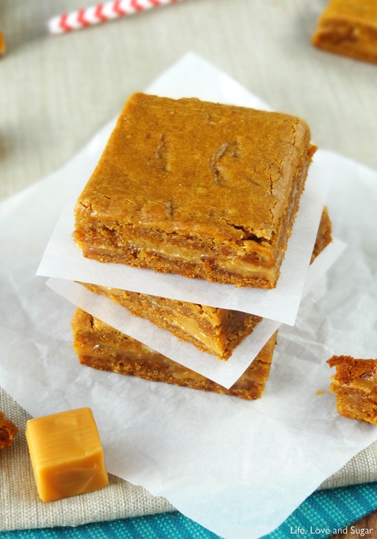 Top view of three Gooey Bars stacked between layers of wax paper