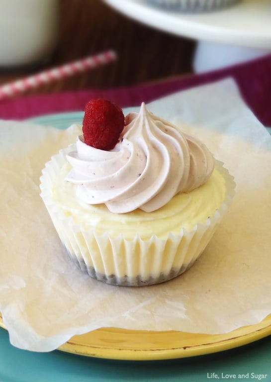 A Cheesecake Ice Cream Cupcake in a cupcake wrapper sits paper lined yellow plate