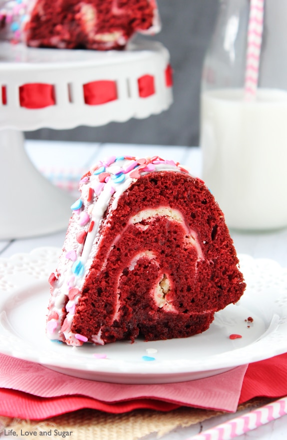A slice of Red Velvet Cheesecake Bundt Cake on a white plate