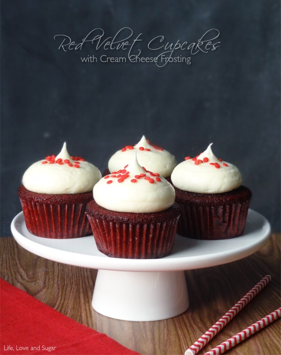 Four Red Velvet Cupcakes with frosting on a white platter