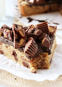 Reese's Peanut Butter Chocolate Chip Cookie Cake slice on waxed paper close up