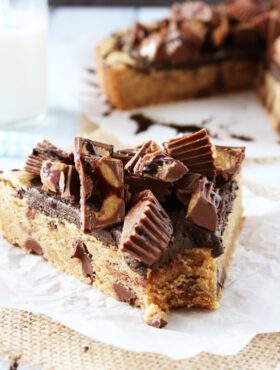 Reese's Peanut Butter Chocolate Chip Cookie Cake slice on waxed paper close up