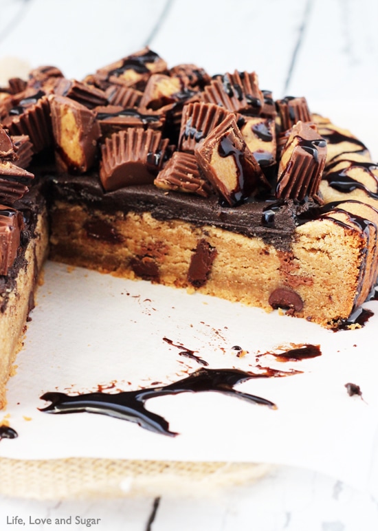 Close-up of Reese's Peanut Butter Chocolate Chip Cookie Cake with a slice removed