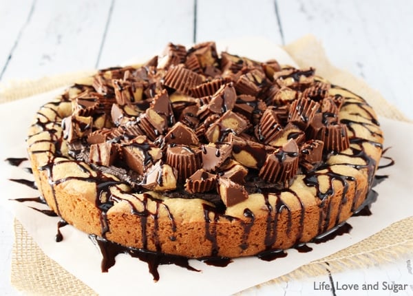 Reese's Peanut Butter Chocolate Chip Cookie Cake on parchment paper