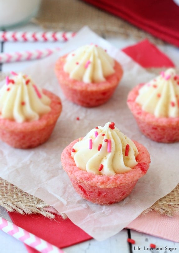 Four Cookie Cups with sprinkles on white paper and burlap