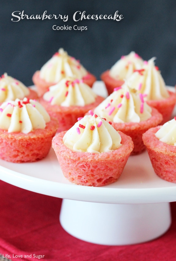 A bunch of little Strawberry Cheesecake Cookie Cups on a white platter