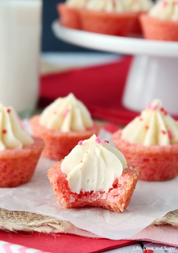 A Cheesecake Cookie Cup with a bite missing and more cookie cups behind it