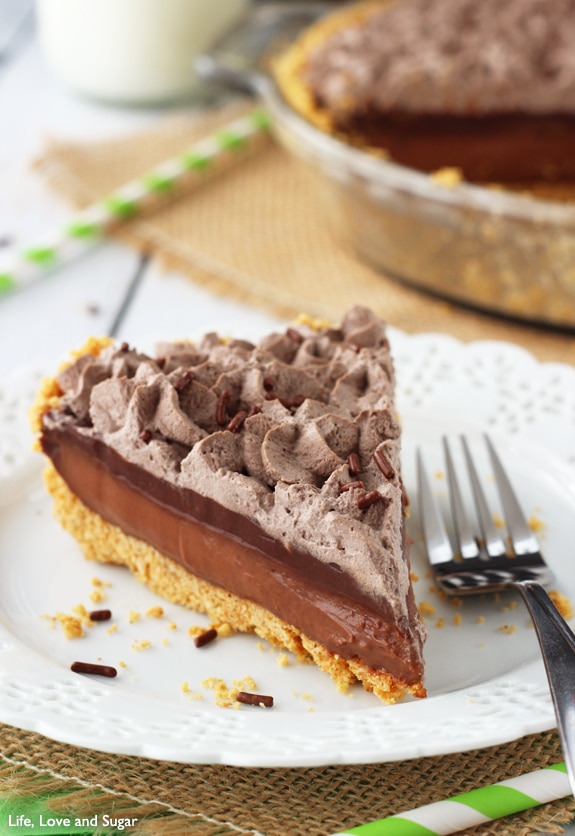 A slice of Baileys Chocolate Pie on a white plate with a fork