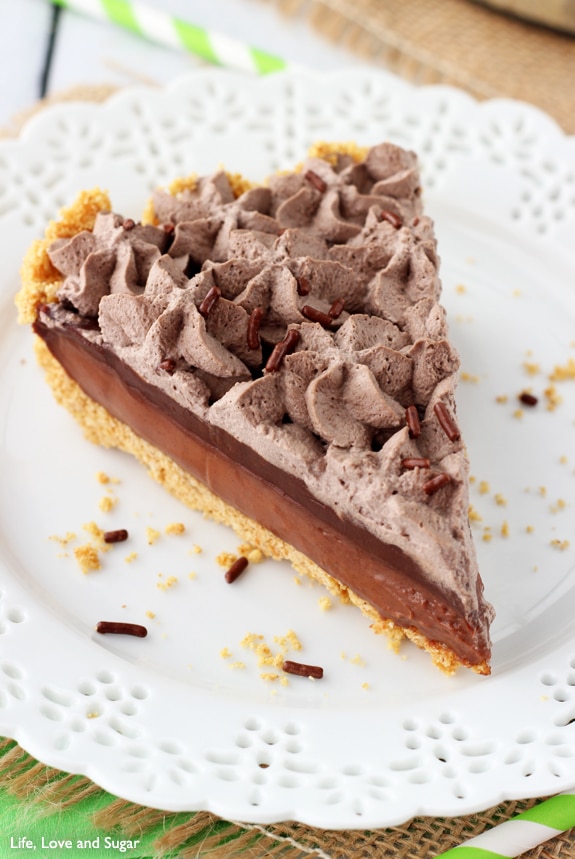 A piece of Baileys Chocolate Pie with layers of chocolate filling, ganache and whipped cream