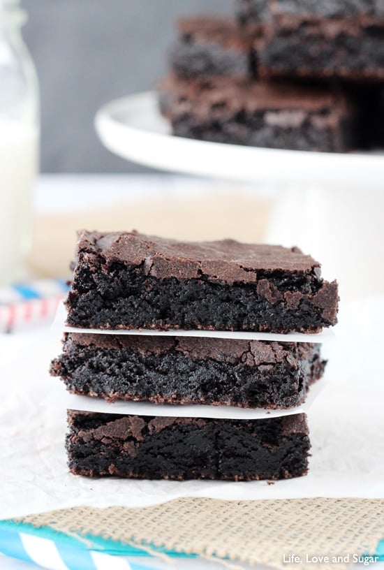 Stack of brownies with parchment paper