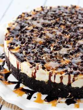 A No-Bake Samoa Cheesecake Topped with Chocolate and Caramel Sauce