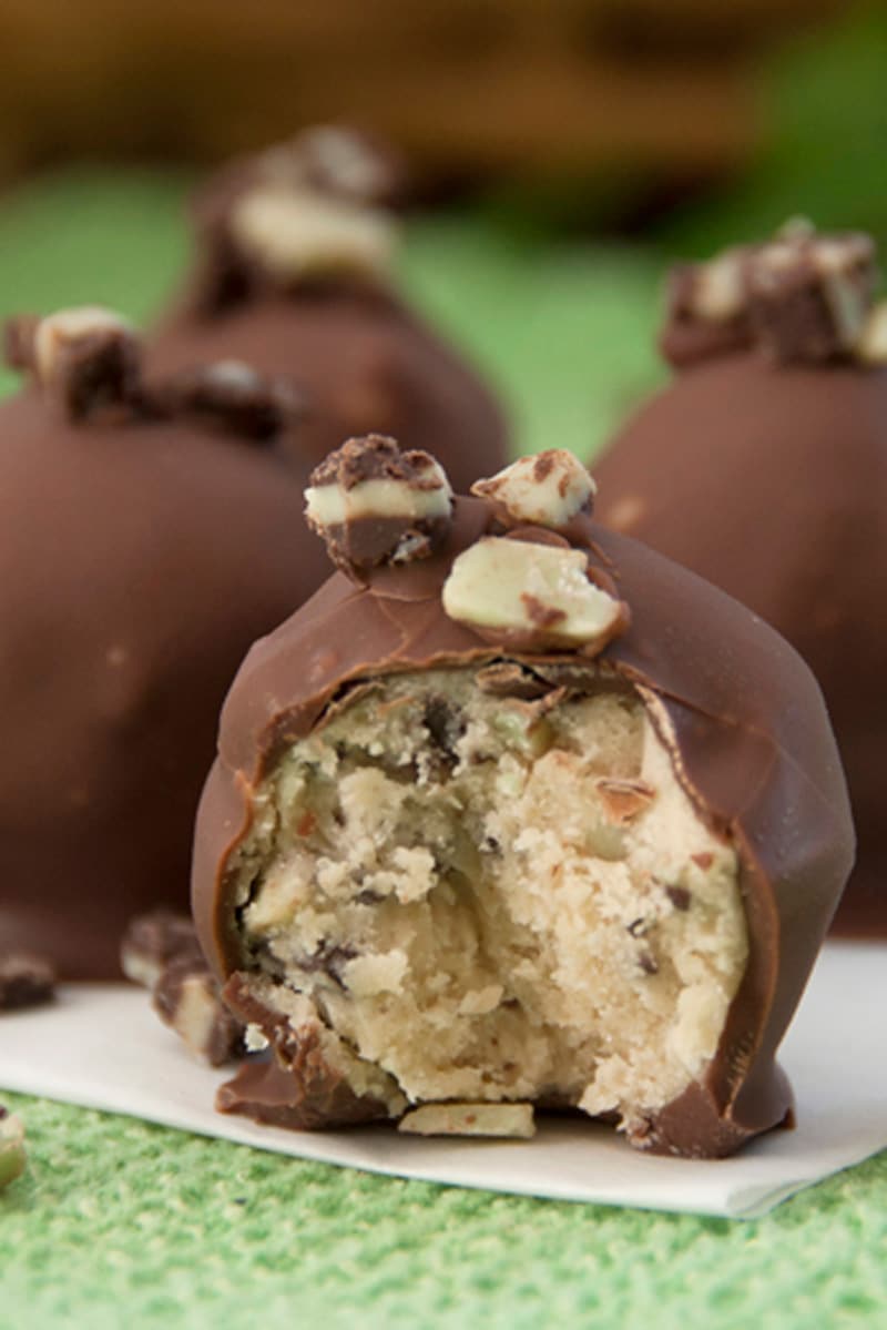 Close up of an Andes Mint Cookie Dough Truffle that is cut open to show the filling.