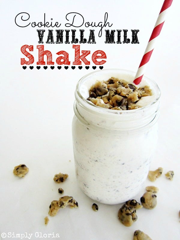 A Cookie Dough Vanilla Milkshake in a mason jar with a red and white straw.