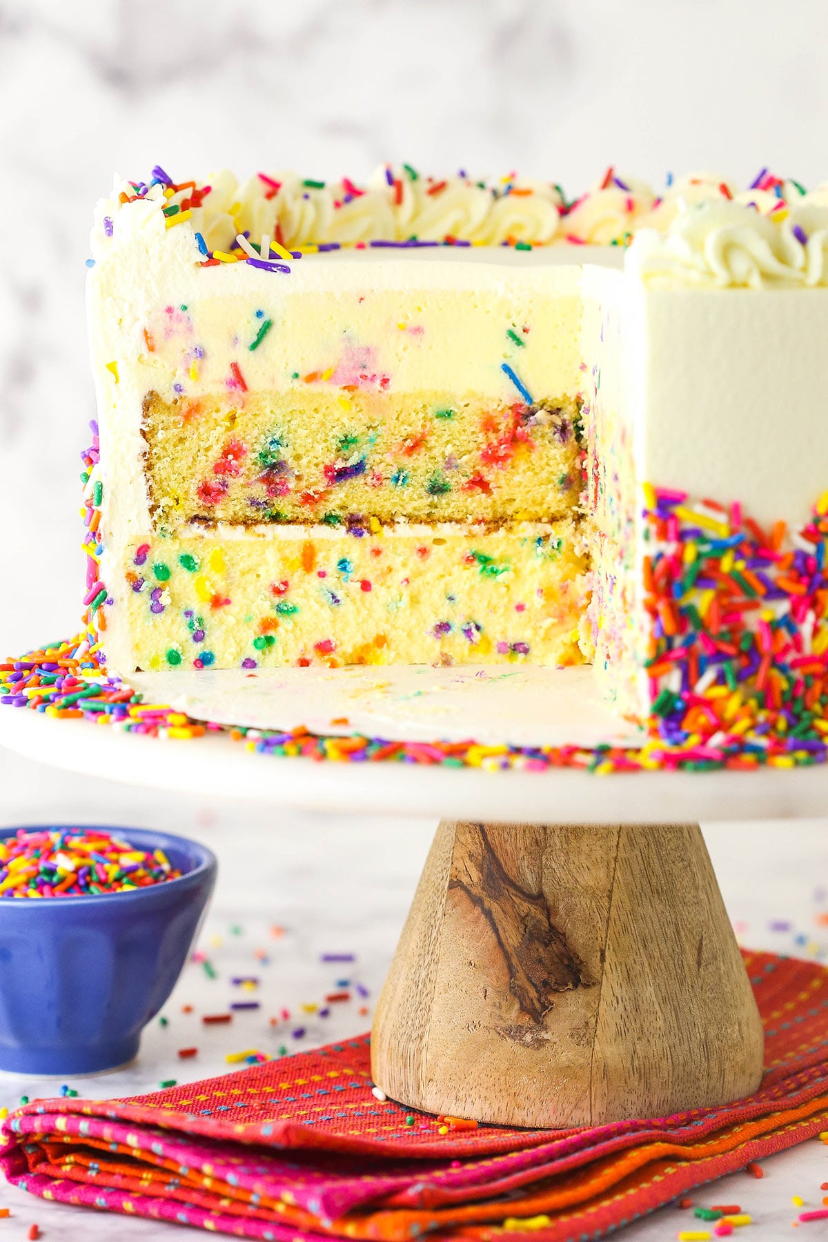 Funfetti millionaire cake with a slice cut out to show the layers