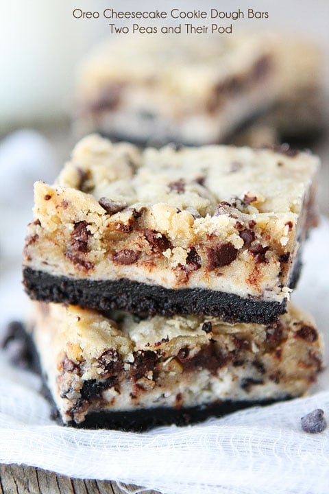 Close up of two stacked Oreo Cheesecake Cookie Dough Bars.
