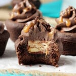 Snickers Chocolate Cookie Cups with a bite out of one