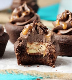 Snickers Chocolate Cookie Cups with a bite out of one