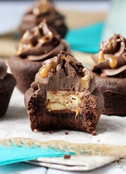 Snickers Chocolate Cookie Cups with a bite out of one