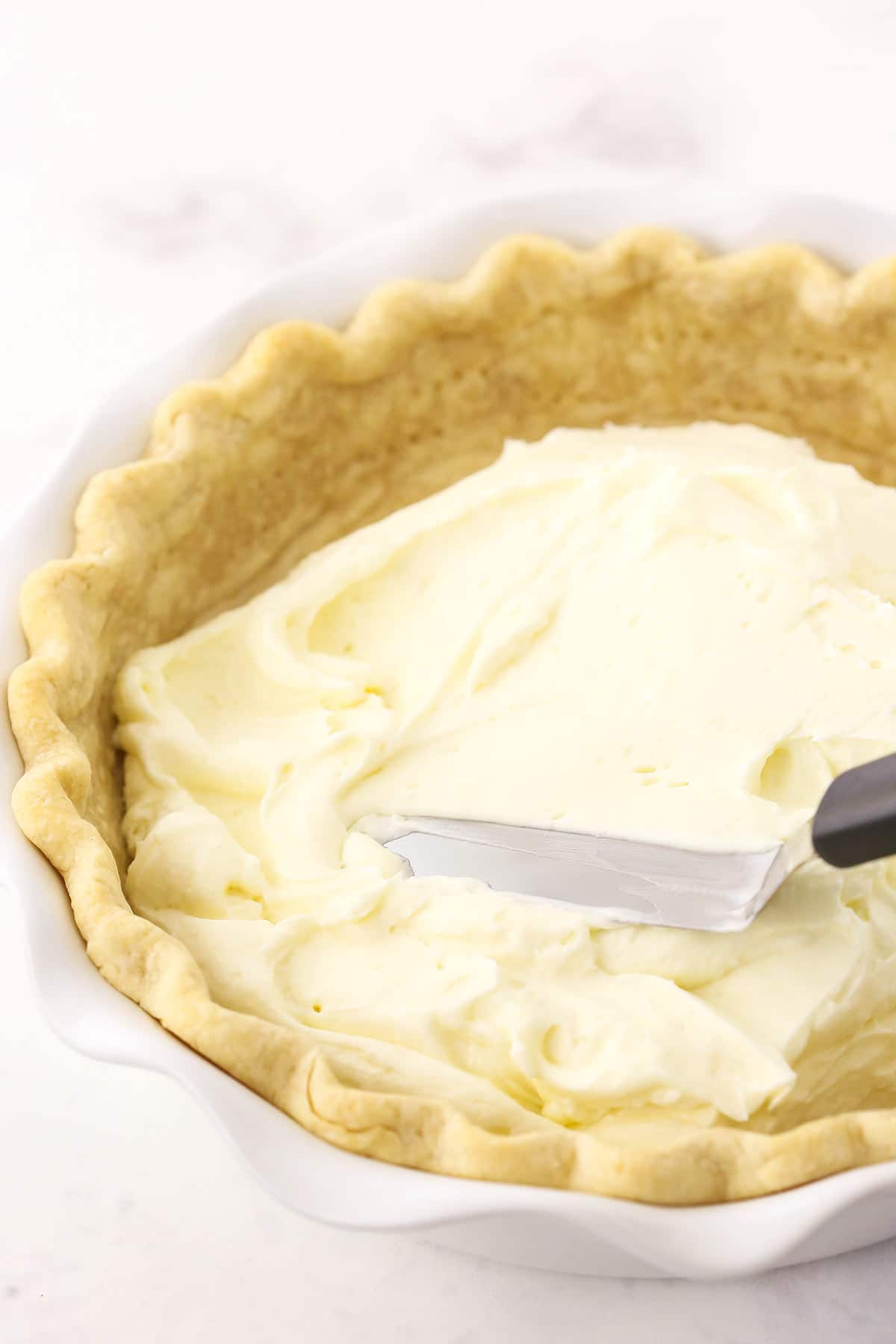 step 5 - spreading cream cheese filling into pie crust