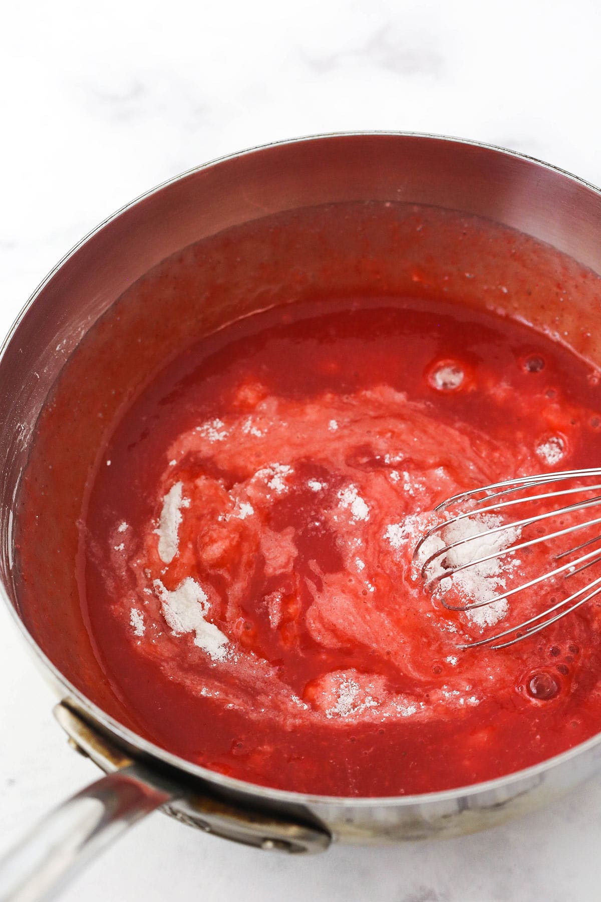 step 7 - cornstarch, sugar and strawberry puree being combined in saucepan