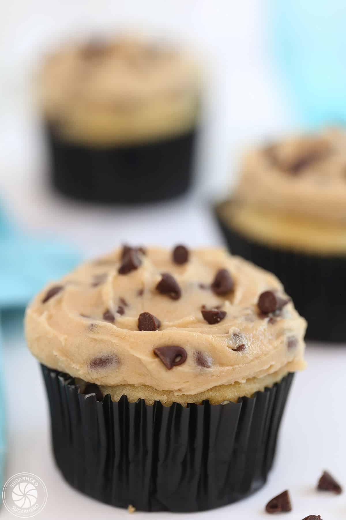A cupcakes covered with cookie dough frosting.