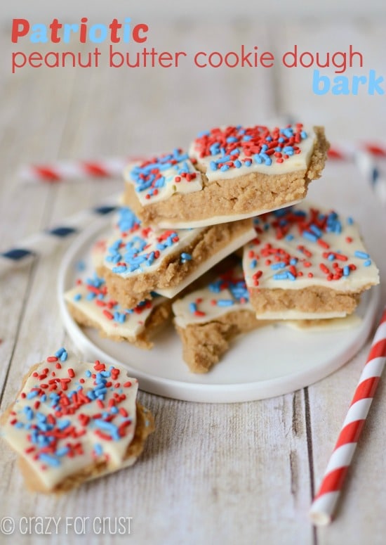 A small white plate piled with pieces of Patriotic Peanut Butter Cookie Dough Bark.