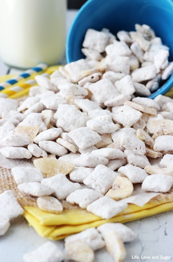 Banana Pudding Puppy Chow poured out of a blue bowl onto a yellow napkin