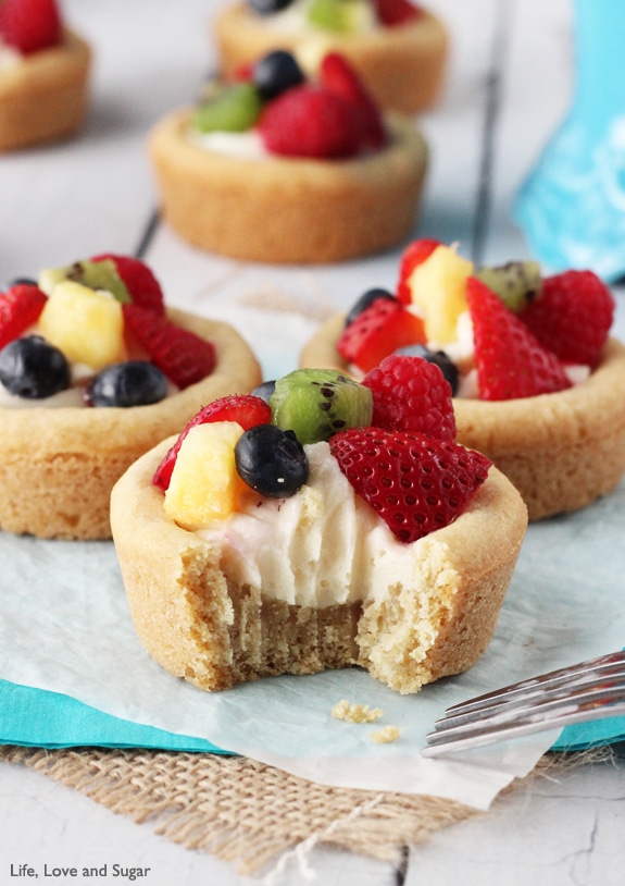 Fruit Cheesecake Sugar Cookie Cups with a bite out of one