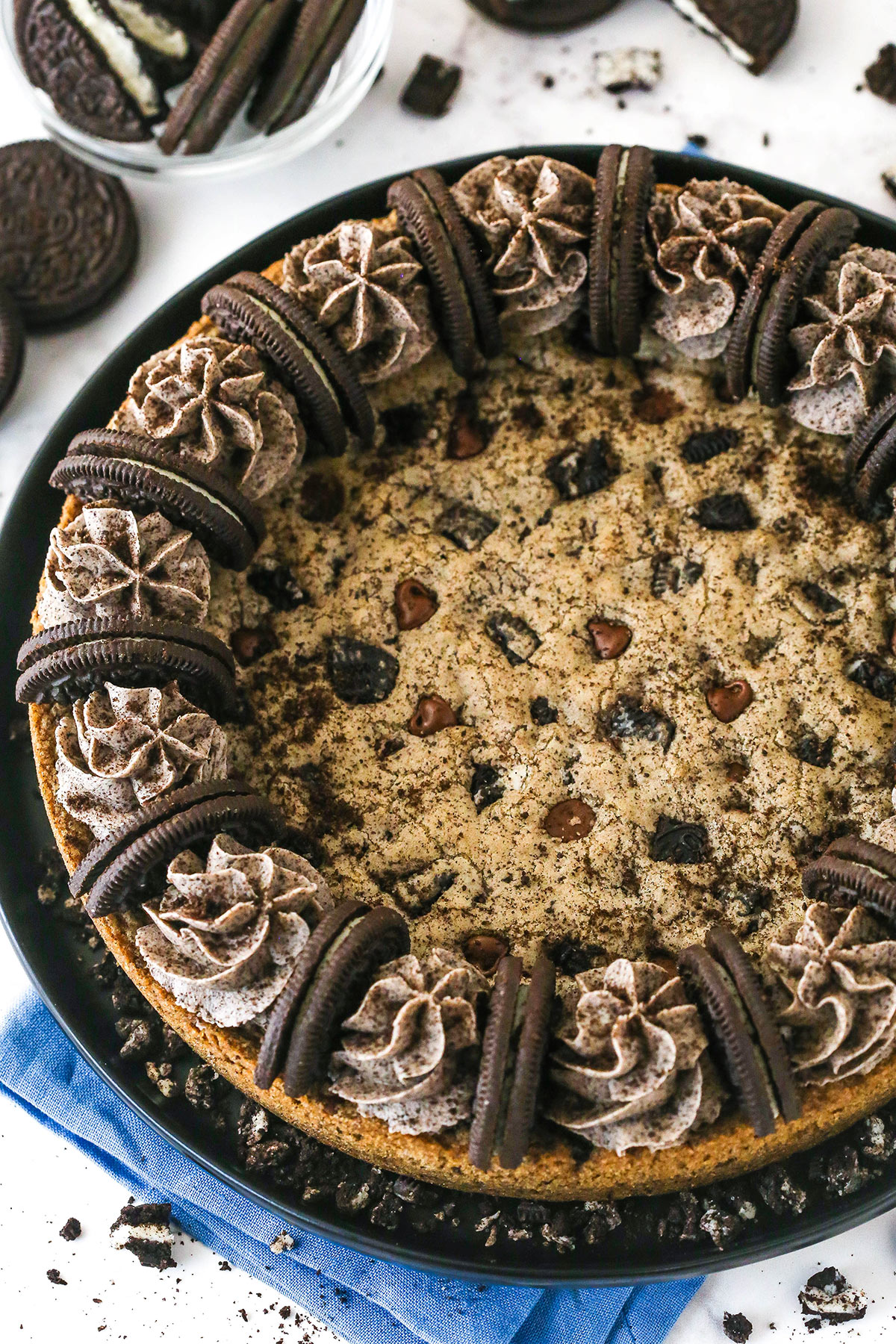 With an Oreo and chocolate chip cookie base and Oreo buttercream on top, this Oreo Cookie Cake is moist, chewy & irresistible. Overhead view of an Oreo cookie cake