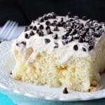 A slice of Cannoli Poke Cake on a white plate