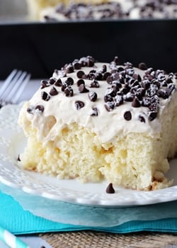 A slice of Cannoli Poke Cake on a white plate