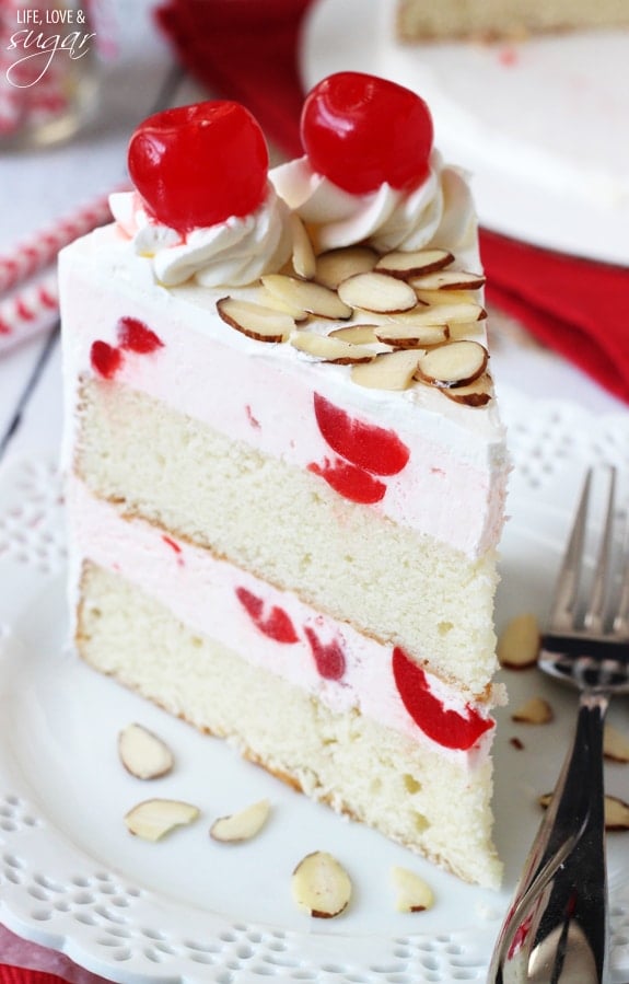 This Cherry Almond Amaretto Ice Cream Cake is light, a little fruity, and full of almond and Amaretto flavor. A refreshing summer dessert! Image of a Slice of Cherry Almond Amaretto Ice Cream Cake on a Plate