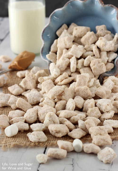 A blue bowl on its size with Fluffernutter Puppy Chow pouring out 