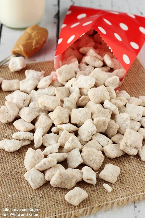 Fluffernutter Puppy Chow pouring out of a red bag onto burlap