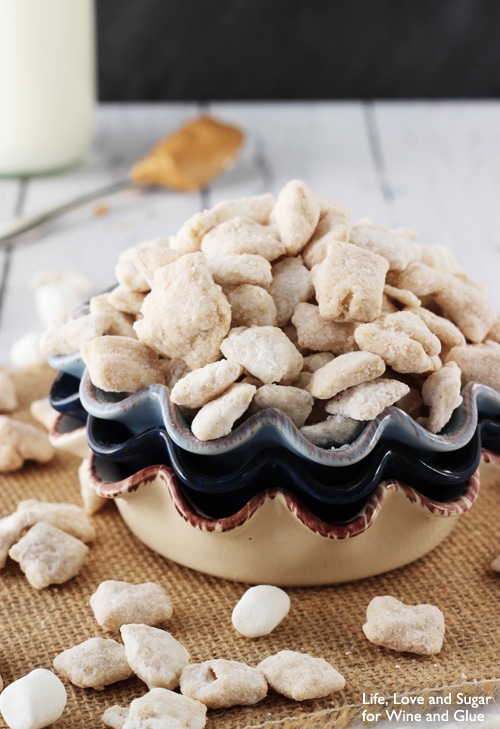 Fluffernutter Puppy Chow piled into a stack of ceramic bowls