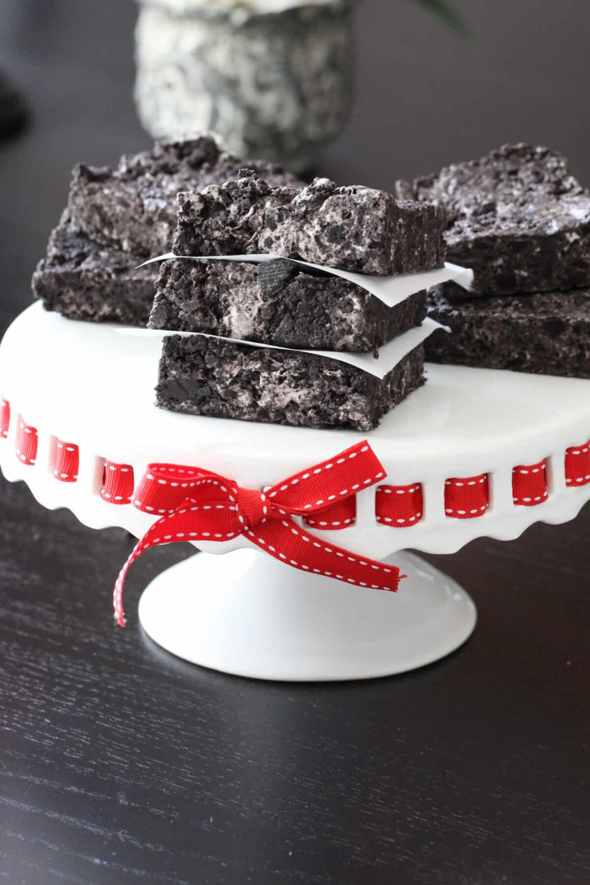 Stacks of No-Bake Cookies and Cream Bars on a white and red cake plate.