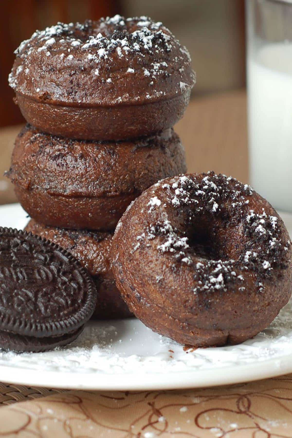 A stack of Mini Chocolate Oreo Donuts on a white plate.