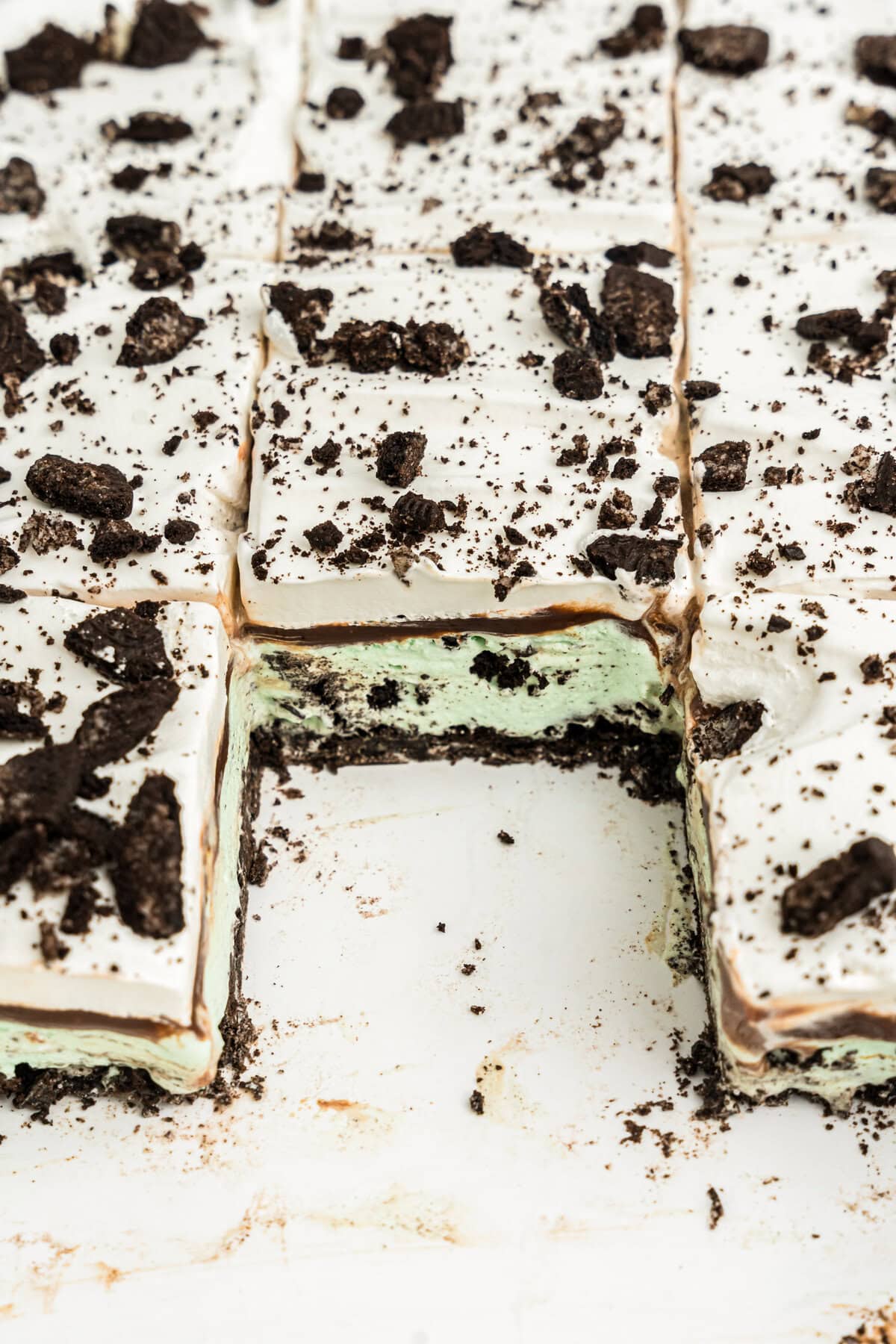 A pan of Mint Oreo Ice Cream Dessert bars with a bar removed.