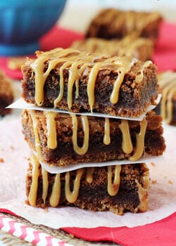 Caramel Nutella Pretzel Brownies stacked on wax paper