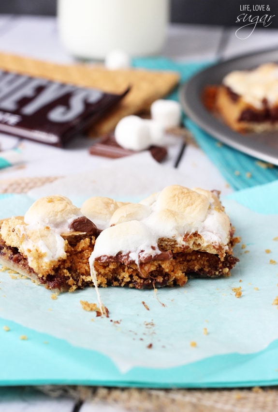 A partially-eaten slice of Smores Pizza on wax paper