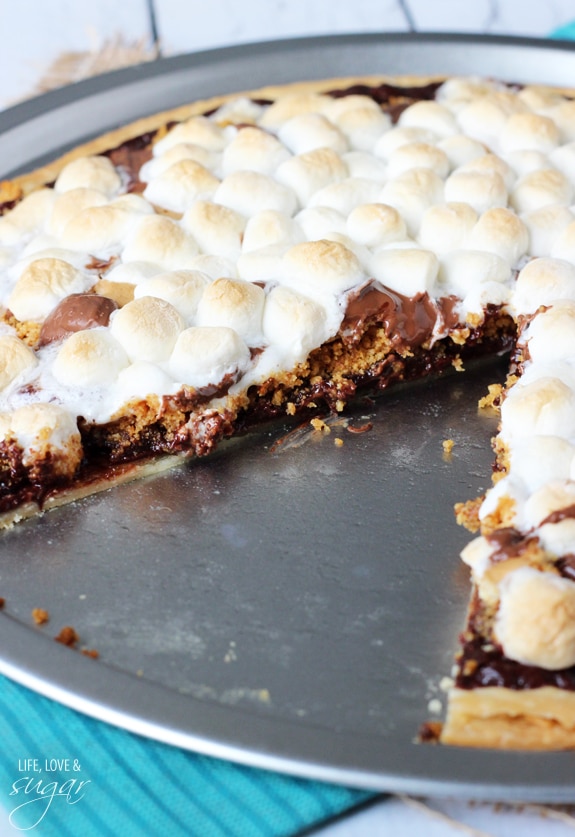 Smores Pizza in a pan with a slice removed