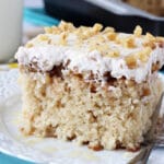 A square of Baklava Poke Cake on a white plate
