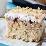 A square of Baklava Poke Cake on a white plate