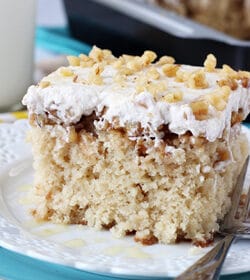 A square of Baklava Poke Cake on a white plate