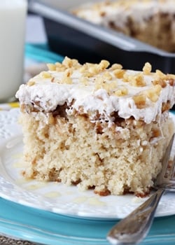 A square of Baklava Poke Cake on a white plate