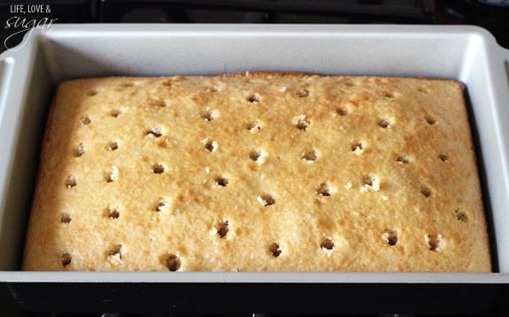 Baklava Poke Cake in a pan with holes poked in it