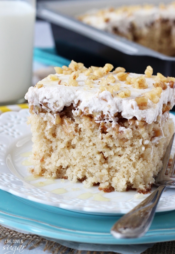 A square of Baklava Poke Cake on a white plate