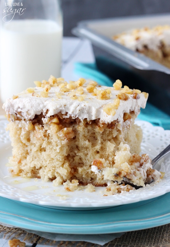 Close-up of a square of Baklava Poke Cake on a white plate